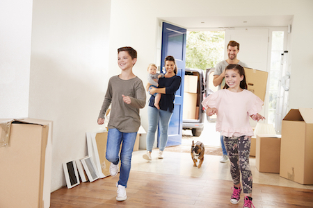 A family moves into their new home with their dog.